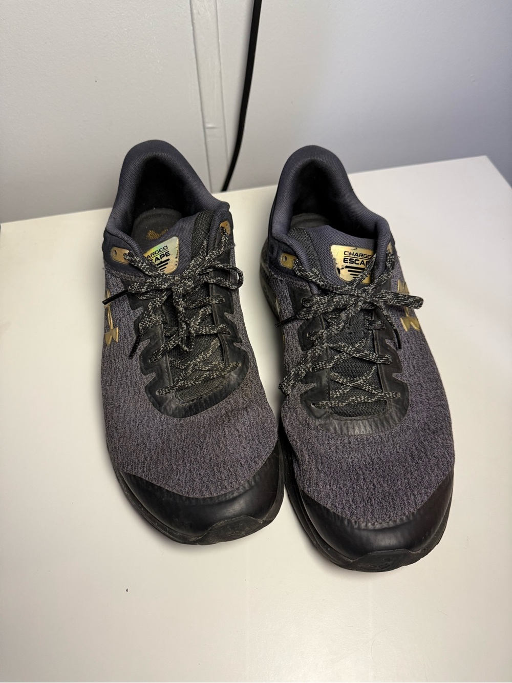 Under Armour Men's Grey and Black Athletic Shoes with Gold Accents